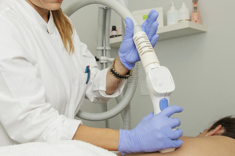 Beauty treatments with stimulating aesthetic clinic appliances applied with gloved hands