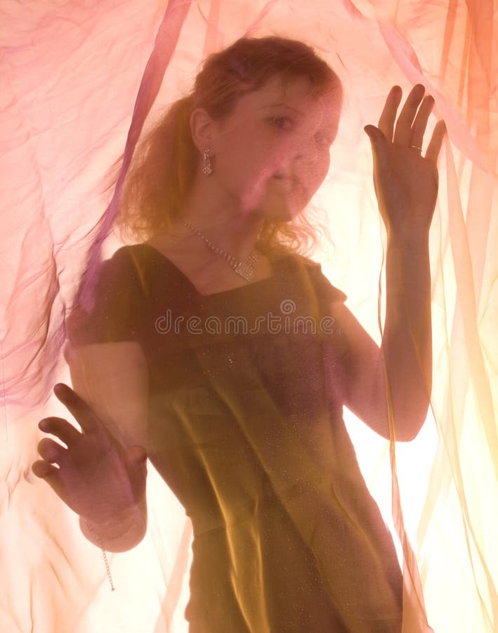 The beauty woman behind a curtain