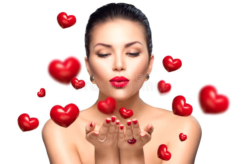 Beauty woman with perfect makeup blowing Valentine hearts. Beauty woman with perfect makeup blowing Valentine hearts