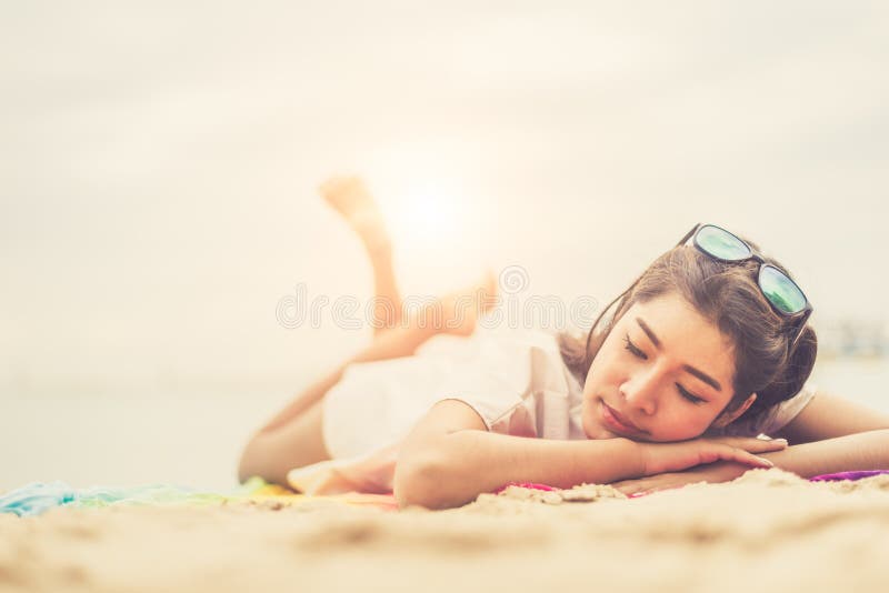 Beauty woman lying on beach. Sea and ocean background People and stock photos Beauty woman lying on beach. Sea and ocean background People and stock photos