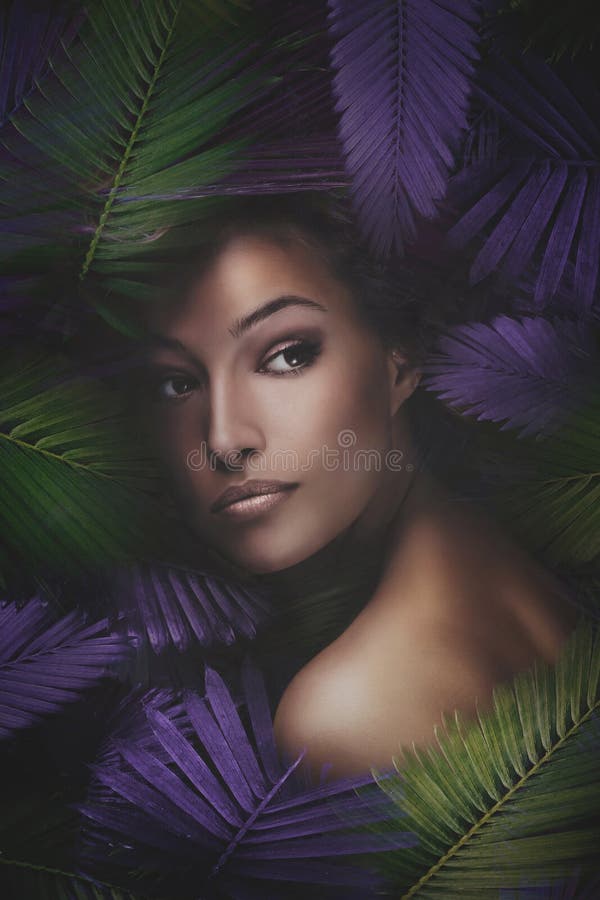 Beauty woman  portrait with exotic leaves stock photography