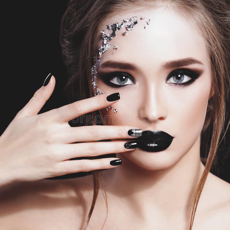 Beauty Woman Portrait. Professional Makeup and Manicure with siver foil glitter, smokey eyes. Black colors. Copy-space