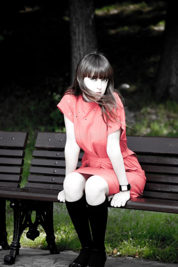 Beauty Woman Sitting On A Park Bench