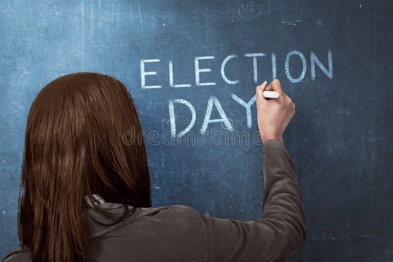 Beauty woman writing a  ELECTION DAY  on blue chalkboard