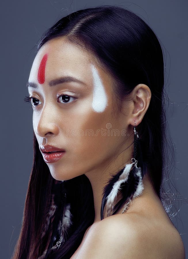 Beauty young asian girl with make up like Pocahontas, red indians woman fashion, close up beauty