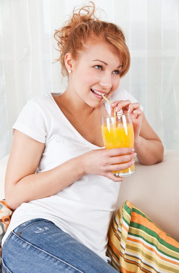 Beauty, young girl drinking a glass of juice