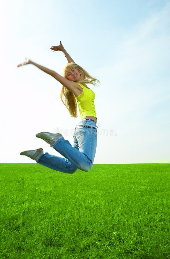 Happy young woman is cover breast and jumping, Stock Photo