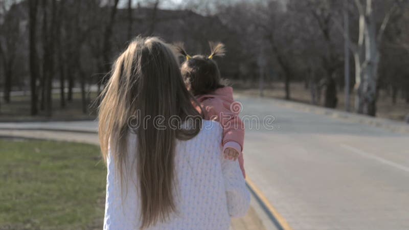 Beb? lindo en los brazos de su madre al aire libre