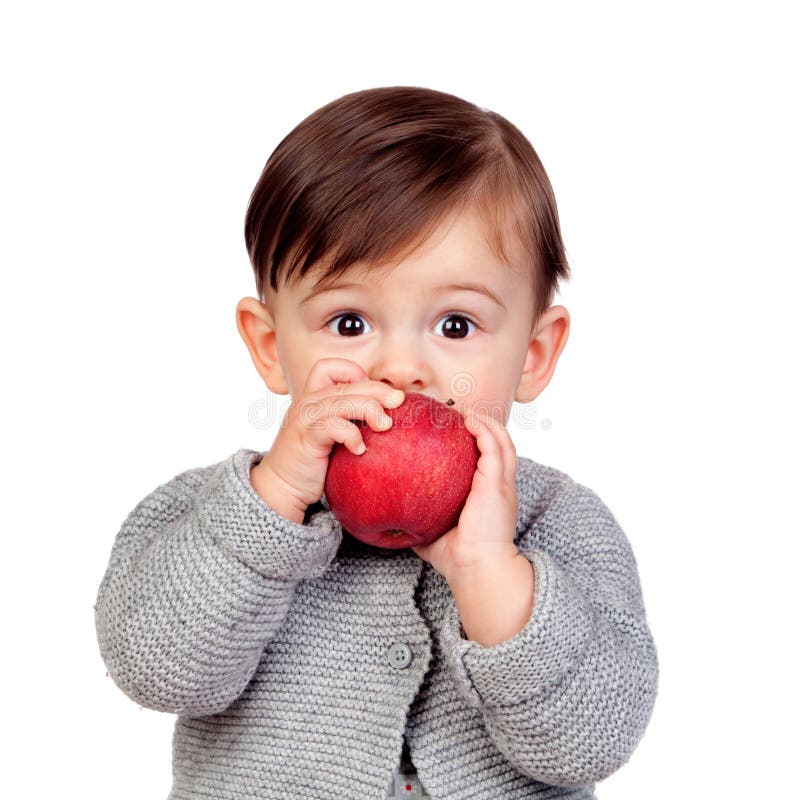 Bebé adorable que come una manzana roja imagen de archivo Bebé adorable que come una manzana roja imagen de archivo