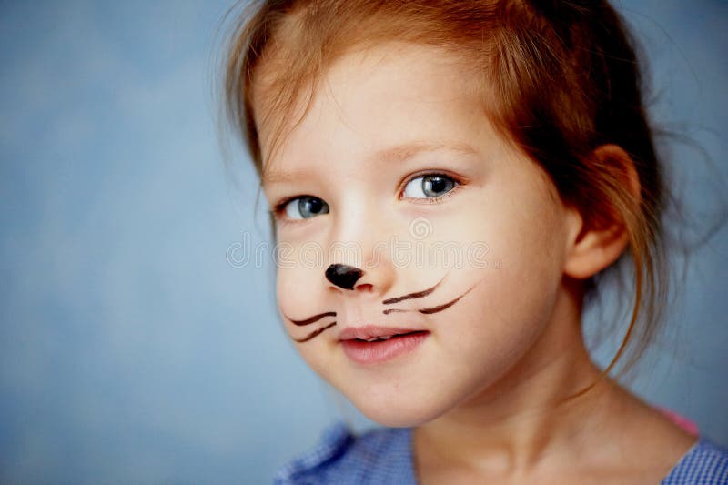 Baby 3 years with face painting of a cat, meowing and smiling. Baby 3 years with face painting of a cat, meowing and smiling