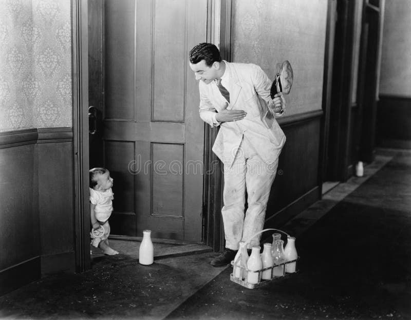 Milkman greeting baby at door (All persons depicted are no longer living and no estate exists. Supplier grants that there will be no model release issues.). Milkman greeting baby at door (All persons depicted are no longer living and no estate exists. Supplier grants that there will be no model release issues.)