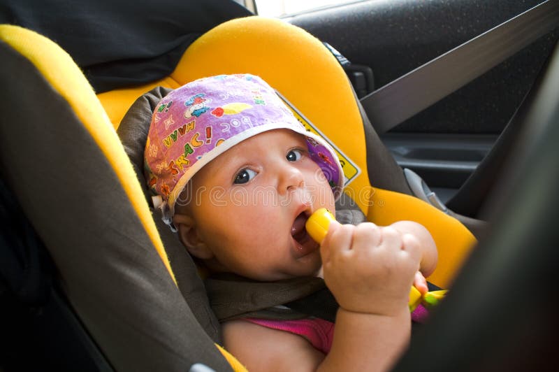 Baby gerl in car child armchair, closeup. Baby gerl in car child armchair, closeup