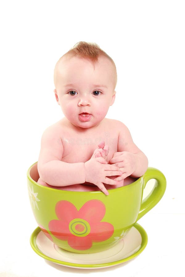 Baby in a big lime green tea cup. Baby in a big lime green tea cup.