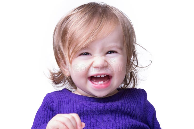 Happy baby is laughing fearless and freely with her new teeths, looking in to camera. Isolated on white. Happy baby is laughing fearless and freely with her new teeths, looking in to camera. Isolated on white.