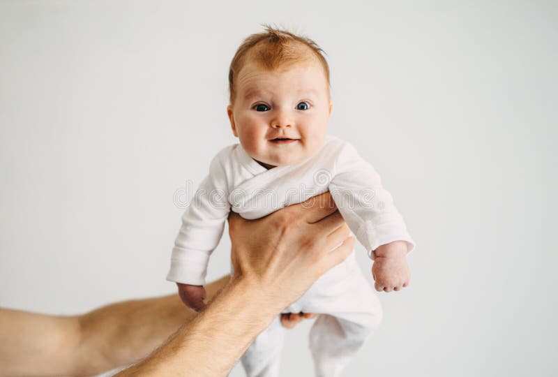 Happy infant baby in father hands adorable 3 month old kid family lifestyle dad and child daughter parenthood concept. Happy infant baby in father hands adorable 3 month old kid family lifestyle dad and child daughter parenthood concept