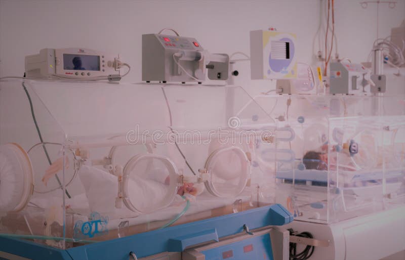 Newborn innocent baby sleeping in an incubator. Newborn innocent baby sleeping in an incubator.