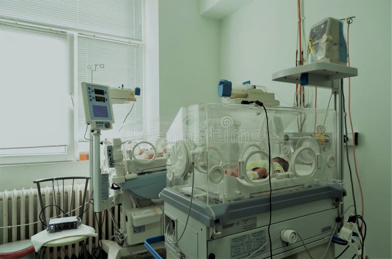 Newborn innocent baby sleeping in an incubator. Newborn innocent baby sleeping in an incubator.
