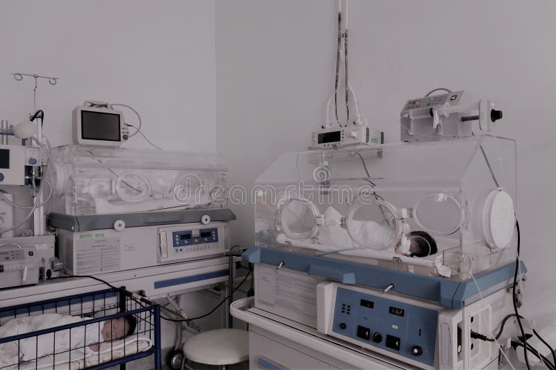 Newborn innocent baby sleeping in an incubator. Newborn innocent baby sleeping in an incubator.