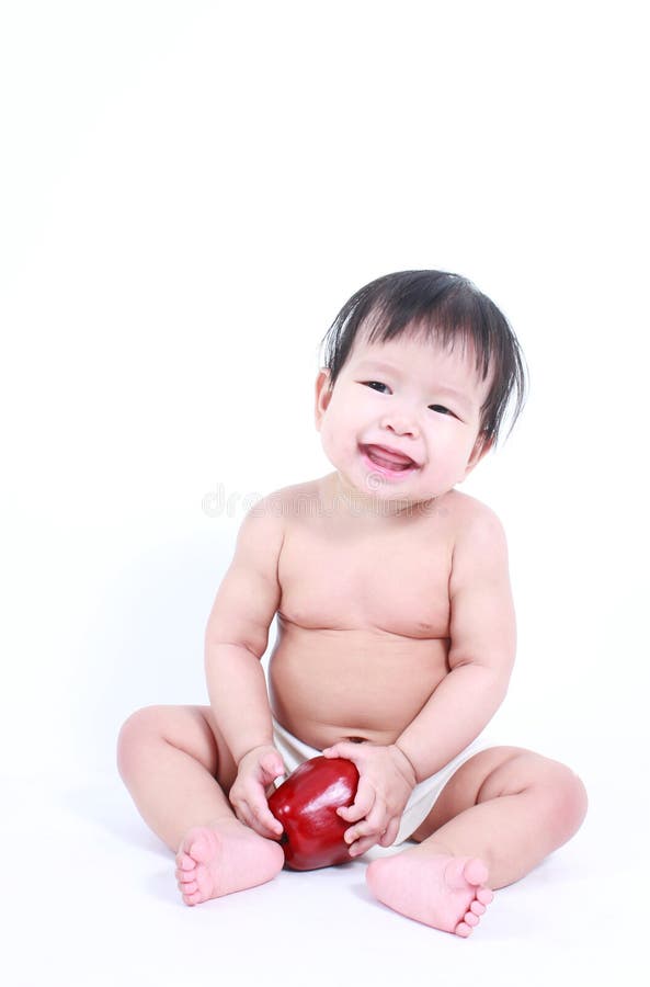 Bebé lindo con la manzana roja que come la comida sana fotografía de archivo Bebé lindo con la manzana roja que come la comida sana fotografía de archivo