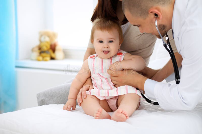 Bebé lindo feliz en el examen de la salud en la oficina del ` s del doctor Concepto de la medicina y de la atención sanitaria foto de archivo Bebé lindo feliz en el examen de la salud en la oficina del ` s del doctor Concepto de la medicina y de la atención sanitaria foto de archivo