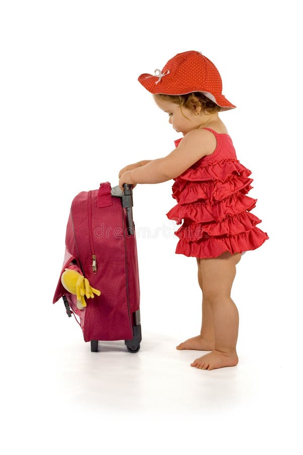 Little girl in purple dress and hat, holding a purple luggage (isolated, with a bit of shadow, clipping path). Little girl in purple dress and hat, holding a purple luggage (isolated, with a bit of shadow, clipping path)