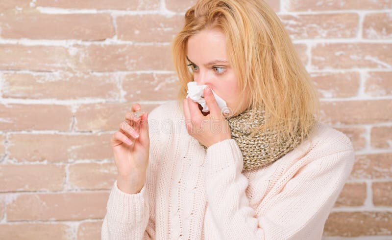 Becoming unwell with cold or flu. Sick woman holding fever thermometer. Cute ill girl measuring body temperature stock photography Becoming unwell with cold or flu. Sick woman holding fever thermometer. Cute ill girl measuring body temperature stock photography