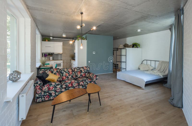 Bed in the Apartment. Bedroom in Studio Apartment. Stock Photo Image