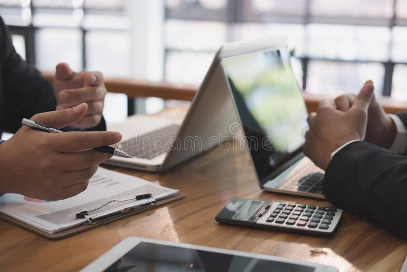 business adviser analyzing company financial report. professional investor discussing balance sheet statement. businessman working on new startup project with co working team. business adviser analyzing company financial report. professional investor discussing balance sheet statement. businessman working on new startup project with co working team.