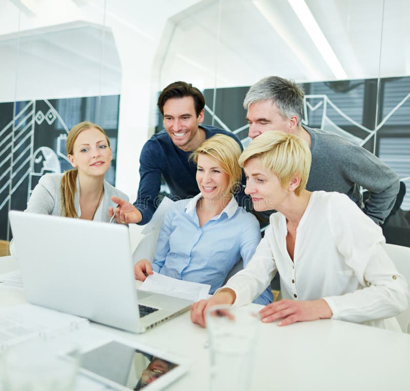 Happy business people getting computer training in the office. Happy business people getting computer training in the office