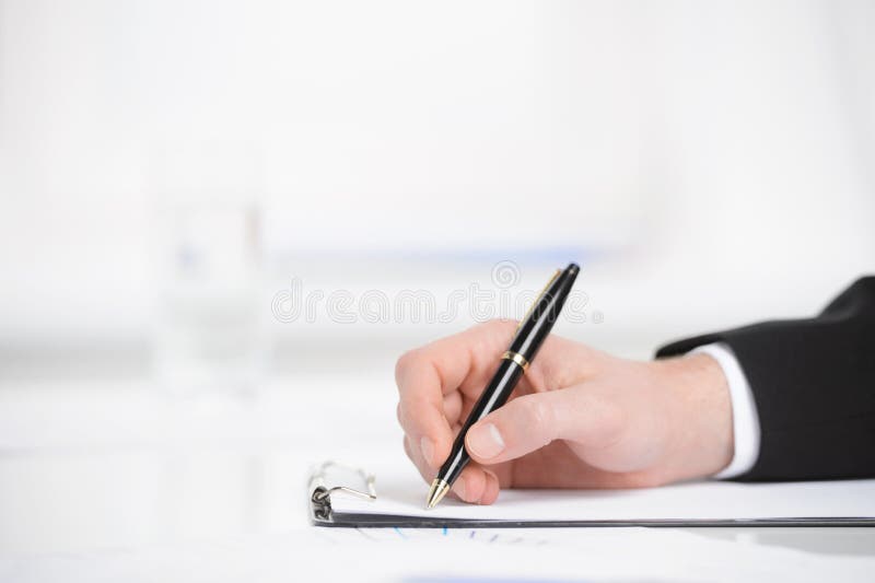 Taking Business notes. Close-up of hand writing something in a note pad. Taking Business notes. Close-up of hand writing something in a note pad