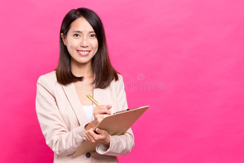 Business woman taking note on clipboard ,asian young woman. Business woman taking note on clipboard ,asian young woman