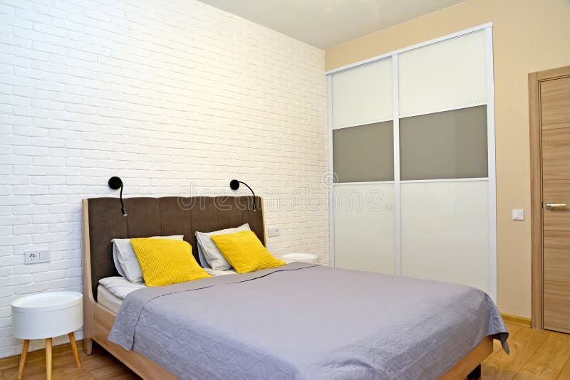 Bedroom with Double Bed and Bedside Tables. Stock Photo