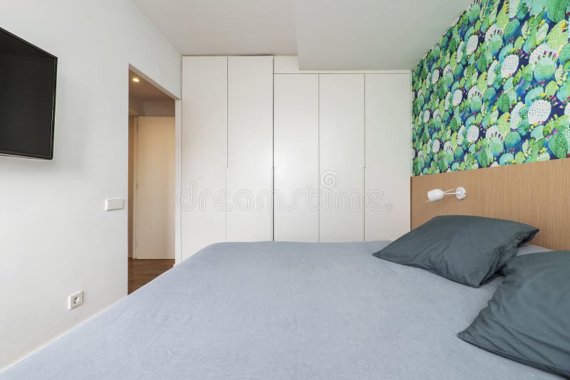 Bedroom with Double Bed with Bright Gray Cushions, Indigo Blue Wall