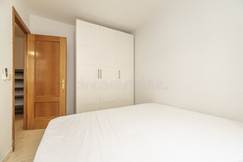 Bedroom with a Double Bed and a White Threesection Wardrobe and an Oak