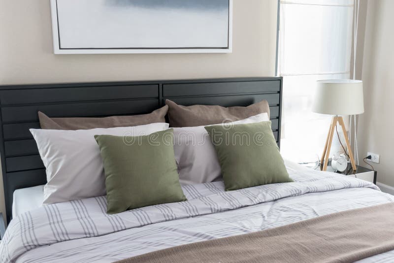 Bedroom with green pillows stock photo. Image of home 55211540