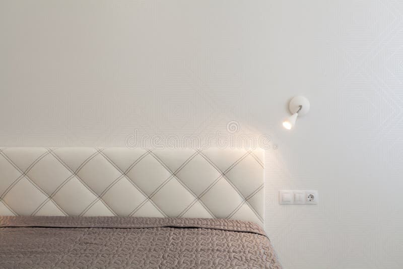 Bedroom Interior. White Head of Bed and Minimal Lamp Stock Image