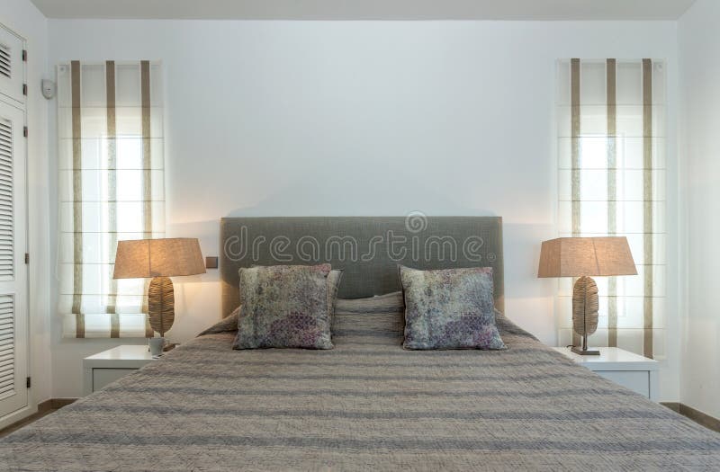 Bedroom in modern style with bed and pillows. Front view. stock images