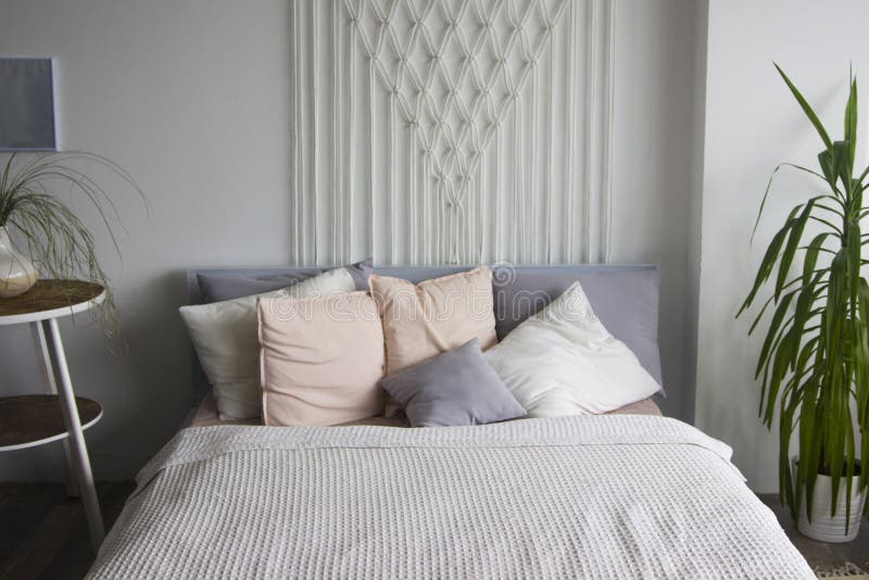 Bedroom in soft light colors. big comfortable double bed in elegant classic bedroom. White double bed with pillows. Bedroom interi stock photography Bedroom in soft light colors. big comfortable double bed in elegant classic bedroom. White double bed with pillows. Bedroom interi stock photography