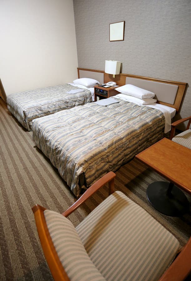 Beds in a hotel room stock image. Image of business 137042615
