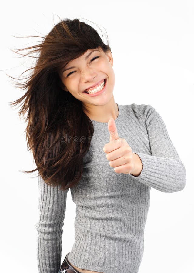 Very excited young mixed caucasian / asian woman giving thumbs up. Very excited young mixed caucasian / asian woman giving thumbs up