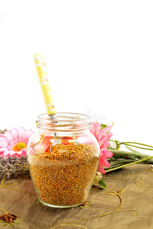 Bee pollen in glass jar and spoon