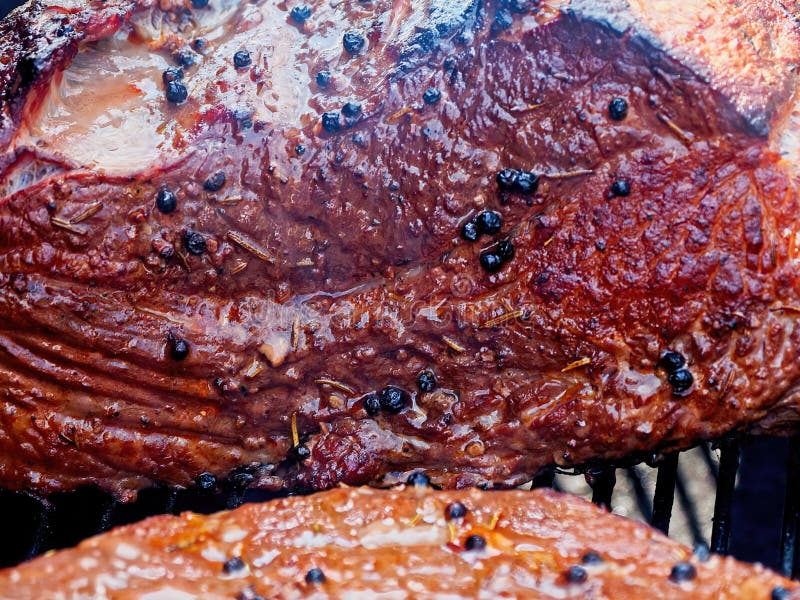 Beef brisket in the smoker stock photo. Image of seasoning 223652298