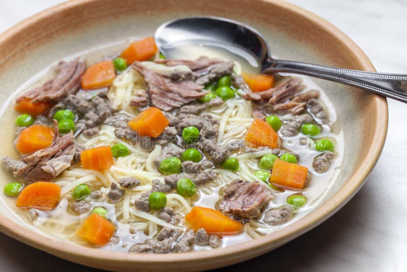 Beef Broth with Green Peas, Carrot and Small Meatballs Stock Photo