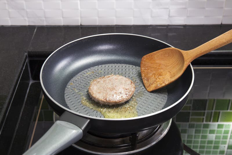 Beef Burger deep fried in the pan royalty free stock photo