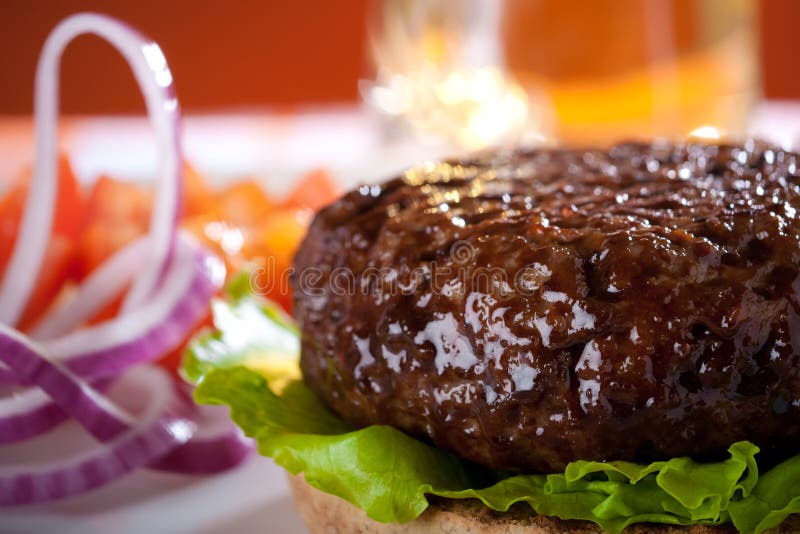 Beef burger with onion and beer on background stock photography