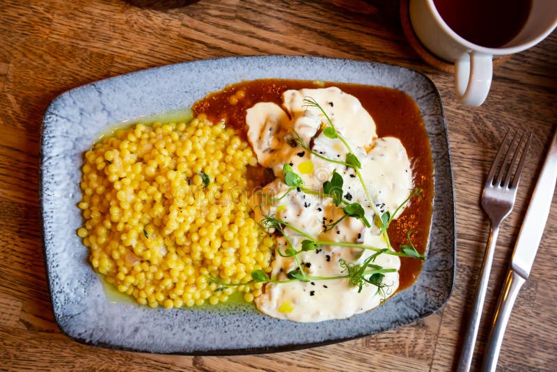 Beef Cheeks with Ptitim Pasta Under Creamy Mushroom Sauce Stock Photo
