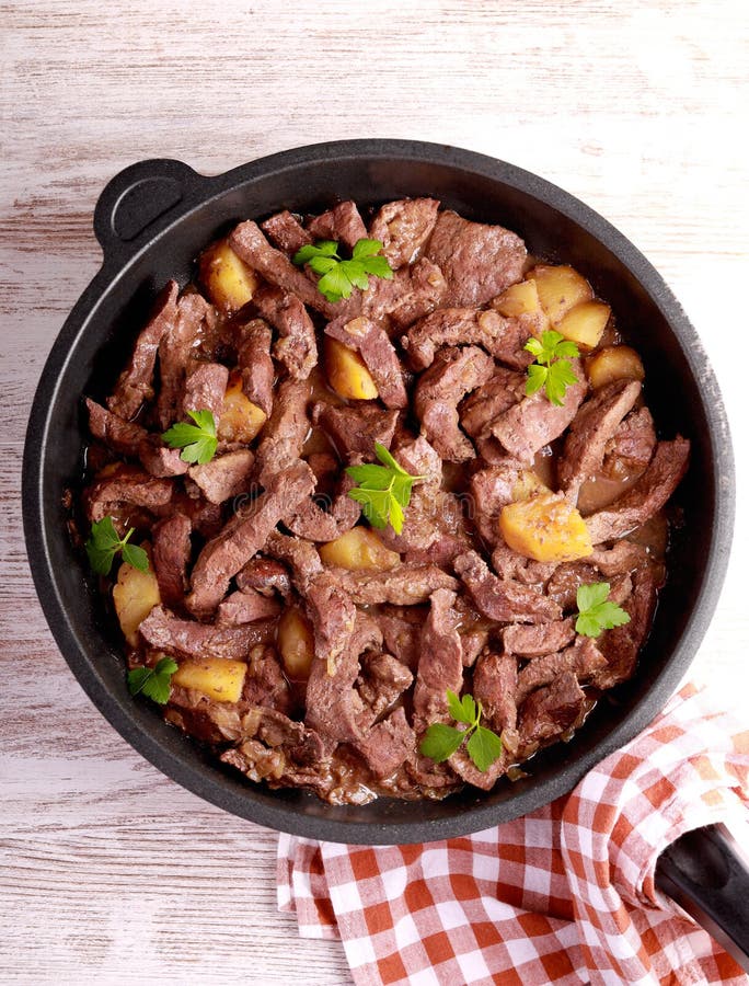 Beef liver and apples stew stock photo. Image of beef 269727418