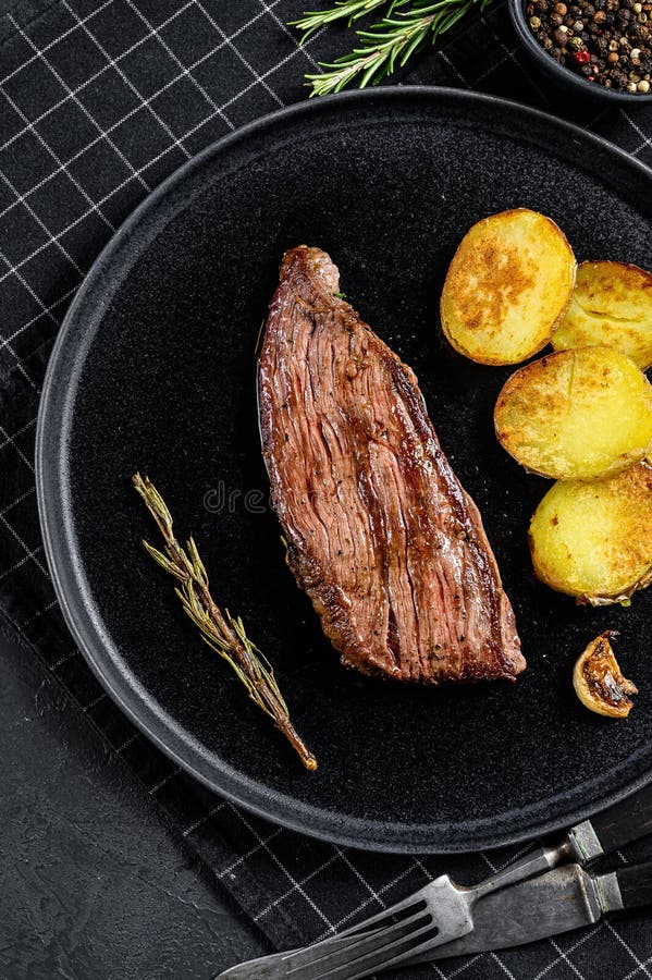 Beef Marble Flank Steak Medium Rare. Black Background Stock Photo