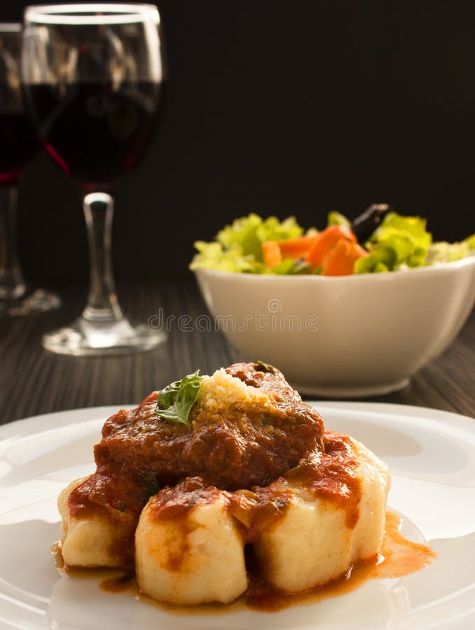 Beef with sauce and gnocchi