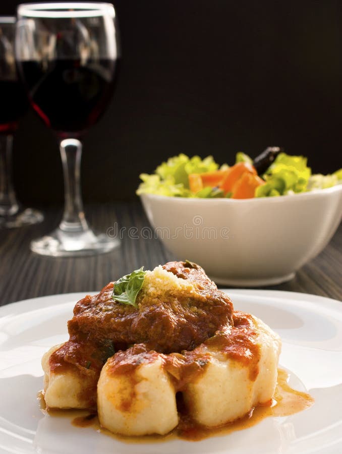 Beef with sauce and gnocchi